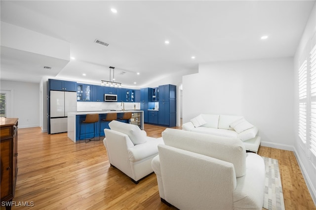 living room featuring light hardwood / wood-style floors and sink