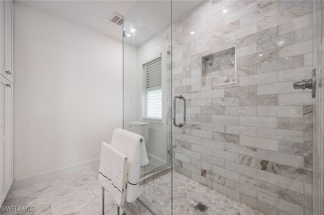 bathroom featuring a shower with shower door