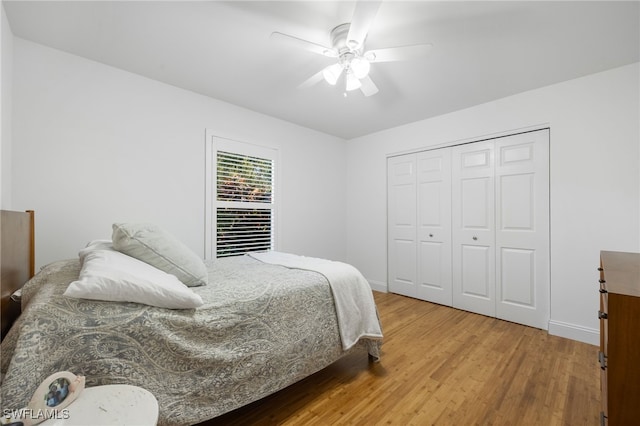 bedroom featuring ceiling fan, a closet, and hardwood / wood-style flooring