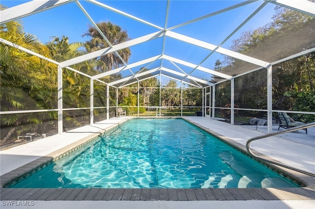 view of swimming pool featuring a lanai and a patio area