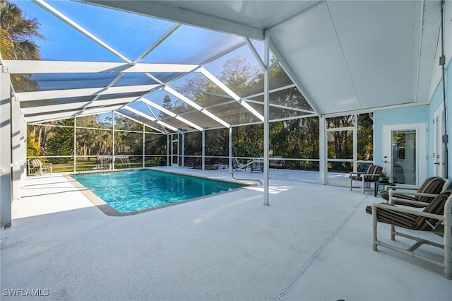 view of pool with a patio and glass enclosure