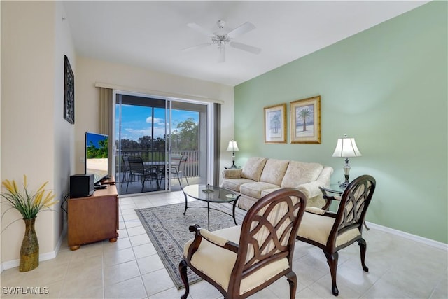 living area with baseboards, ceiling fan, and light tile patterned floors