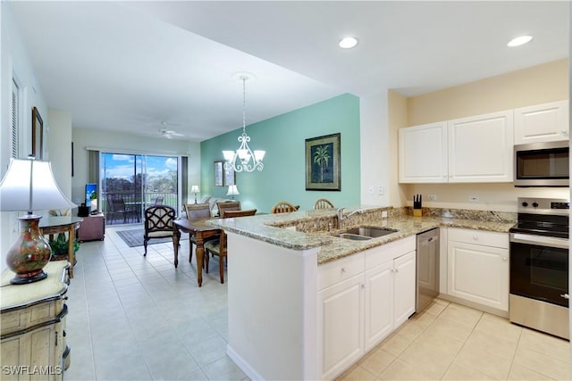 kitchen with white cabinets, appliances with stainless steel finishes, sink, hanging light fixtures, and kitchen peninsula