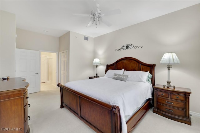 bedroom featuring a ceiling fan, a closet, light colored carpet, and visible vents