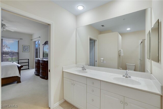 bathroom with toilet, ceiling fan, and vanity