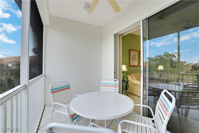 sunroom / solarium featuring ceiling fan and plenty of natural light