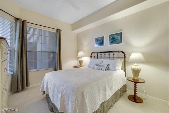 bedroom featuring baseboards, carpet flooring, and a ceiling fan