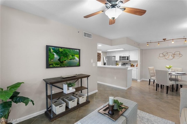 tiled living room with ceiling fan