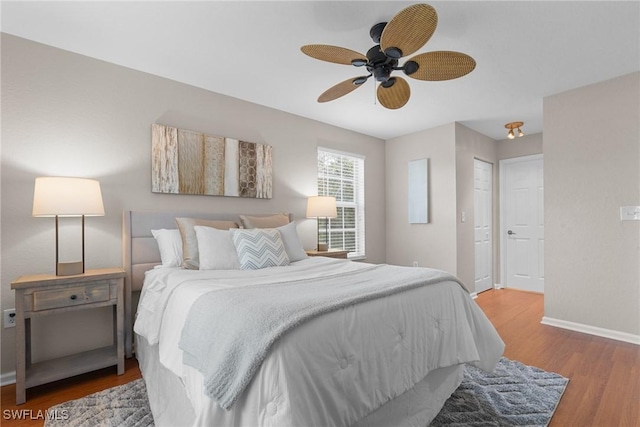 bedroom with ceiling fan and hardwood / wood-style flooring