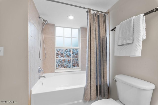 bathroom with toilet and shower / tub combo