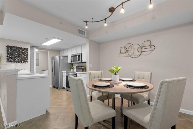 tiled dining area featuring sink