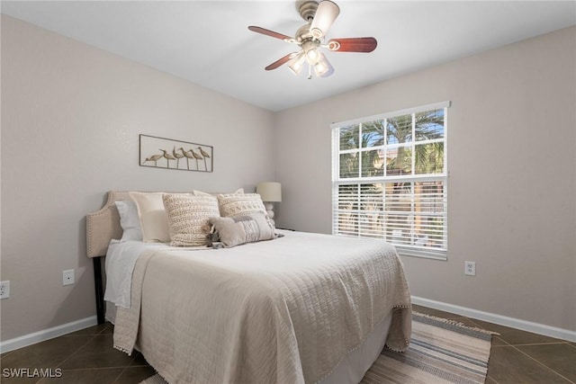 tiled bedroom featuring multiple windows and ceiling fan