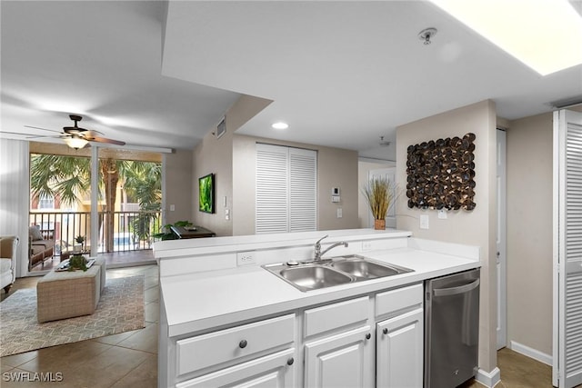 kitchen with stainless steel dishwasher, ceiling fan, sink, white cabinetry, and light tile patterned flooring