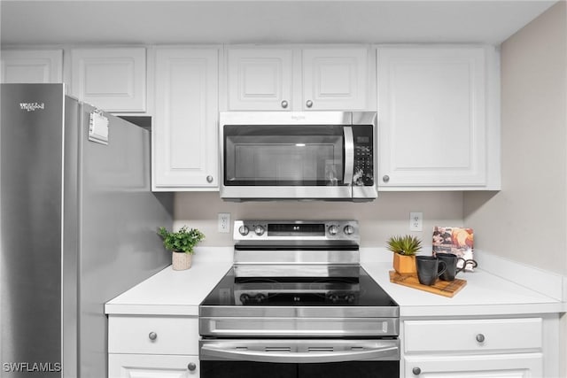 kitchen with white cabinets and appliances with stainless steel finishes