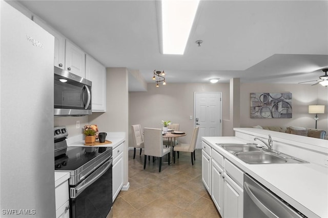 kitchen featuring appliances with stainless steel finishes, white cabinetry, ceiling fan, and sink