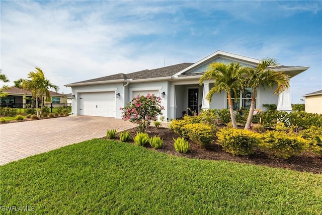 single story home featuring a front yard and a garage