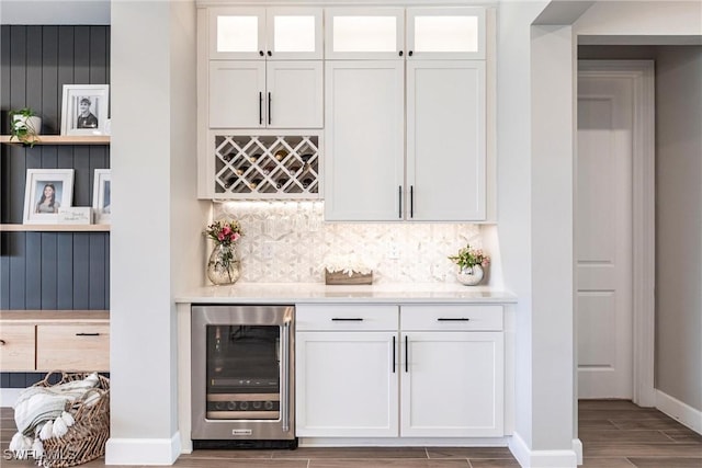 bar featuring white cabinetry, beverage cooler, and tasteful backsplash