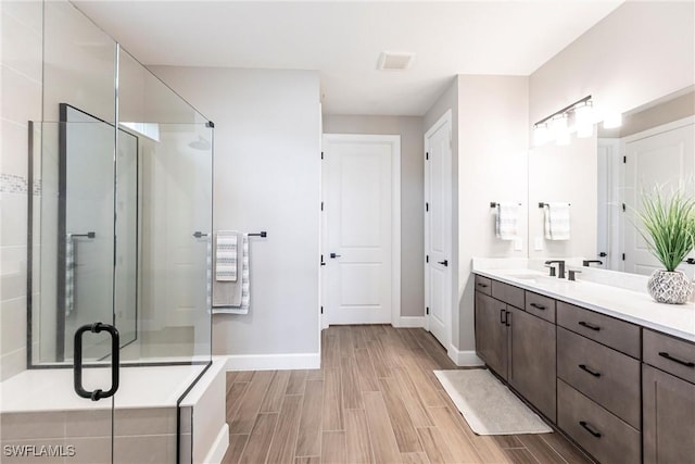 bathroom featuring vanity and a shower with shower door