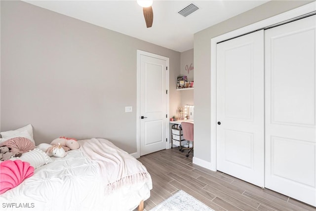 bedroom featuring a closet, ceiling fan, and light hardwood / wood-style floors