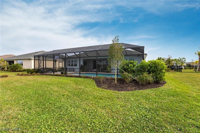 back of house with a lanai and a lawn