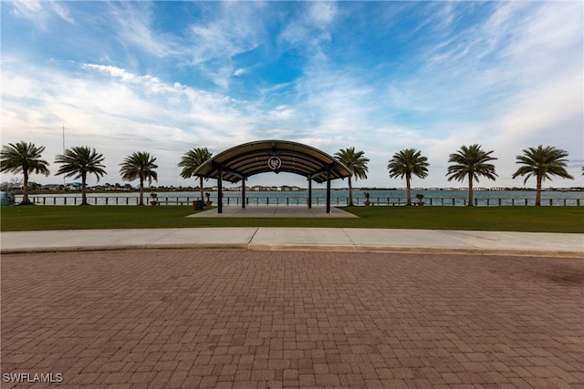 view of community with a yard and a water view