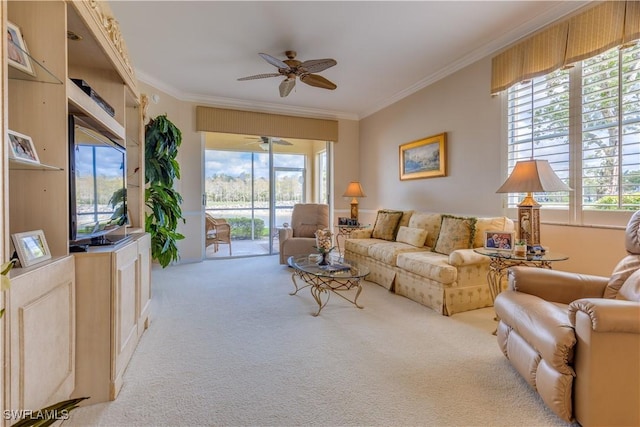 carpeted living room featuring ceiling fan and ornamental molding