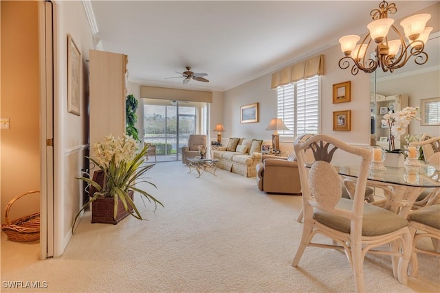 carpeted living room with a healthy amount of sunlight, ceiling fan with notable chandelier, and ornamental molding