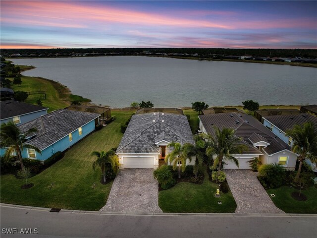 aerial view at dusk with a water view