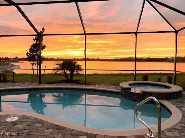 view of pool with a lanai, a water view, and a pool with connected hot tub