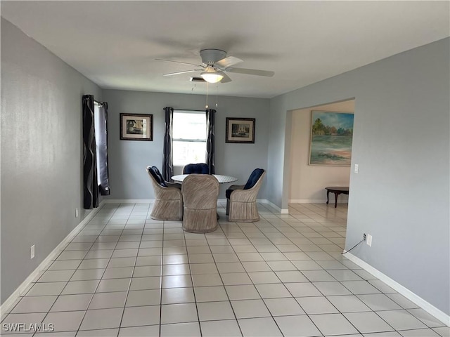 dining room with ceiling fan, baseboards, and light tile patterned floors