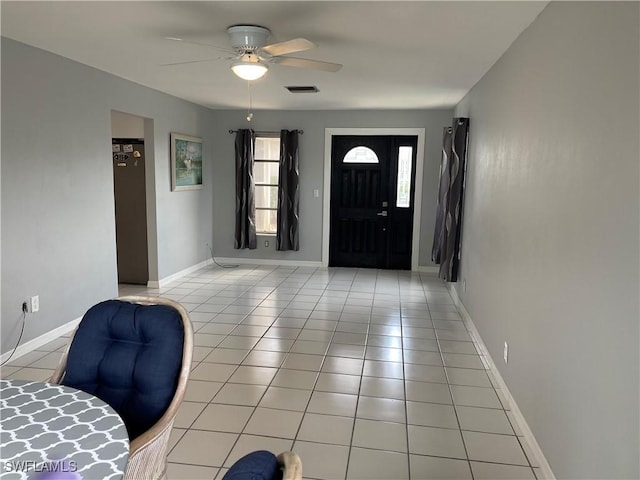 entryway featuring visible vents, ceiling fan, baseboards, and light tile patterned floors