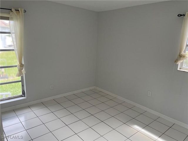 unfurnished room featuring baseboards