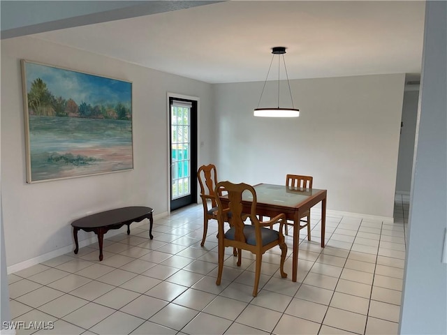 dining area with light tile patterned flooring and baseboards