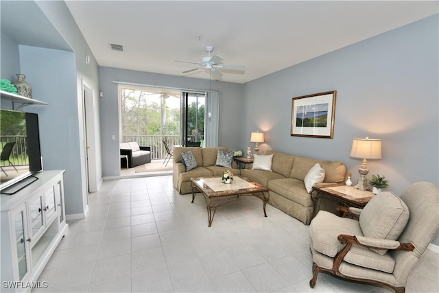 tiled living room featuring ceiling fan