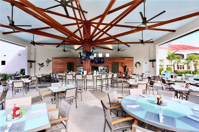 dining space featuring high vaulted ceiling