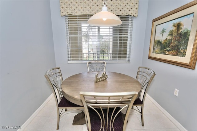 dining space with light tile patterned floors and baseboards