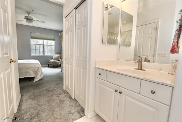 bathroom featuring a closet, vanity, ensuite bathroom, and ceiling fan