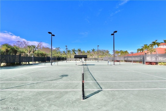 view of sport court featuring fence