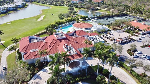 bird's eye view featuring golf course view and a water view