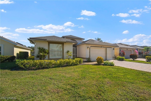 view of front of home with a front yard and a garage