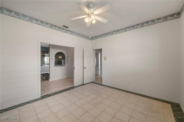 unfurnished room featuring ceiling fan and light tile patterned floors