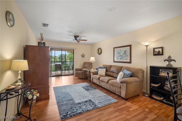 living room featuring ceiling fan and light hardwood / wood-style flooring