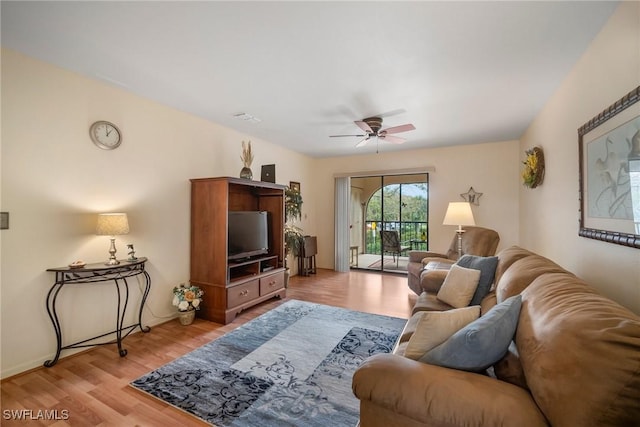 living room featuring ceiling fan and light wood-type flooring