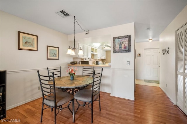 dining room featuring an inviting chandelier and light hardwood / wood-style floors