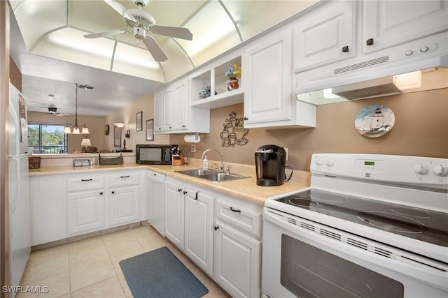 kitchen featuring white appliances, hanging light fixtures, kitchen peninsula, sink, and white cabinetry