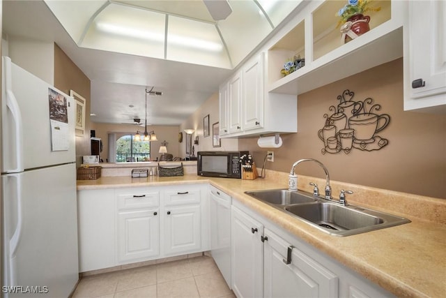 kitchen featuring sink, white appliances, light tile patterned floors, and white cabinets