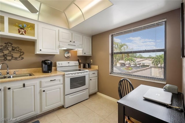 kitchen featuring sink, electric stove, and white cabinetry