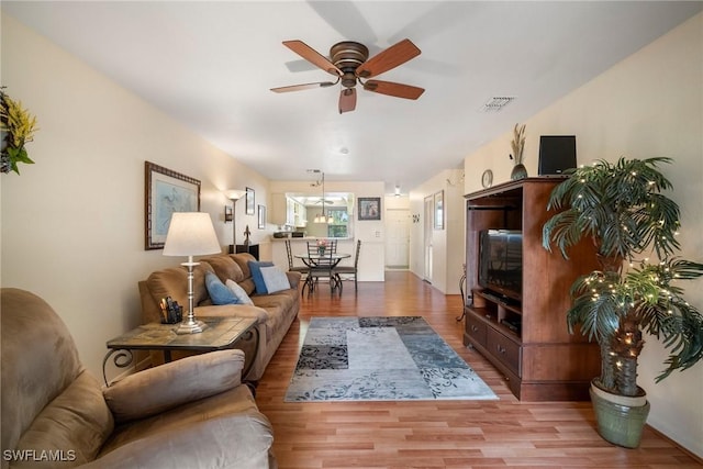 living room featuring ceiling fan and light hardwood / wood-style flooring