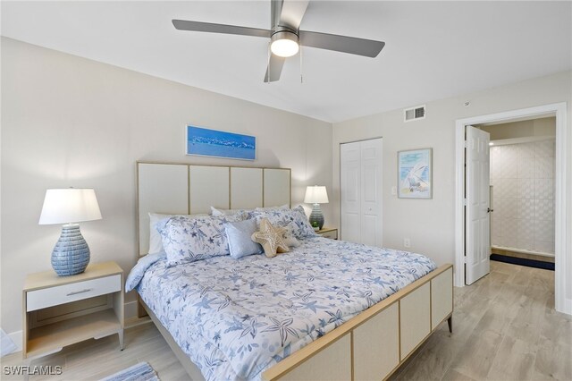 bedroom with ceiling fan, light hardwood / wood-style flooring, and a closet