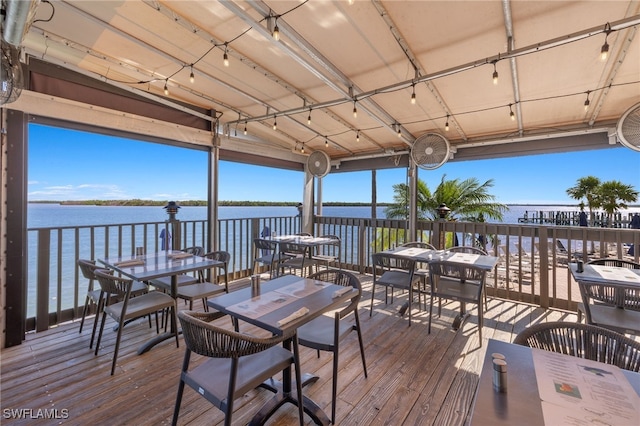 wooden terrace featuring a water view